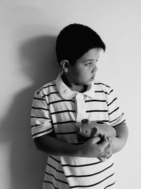 Boy with piggy bank at home