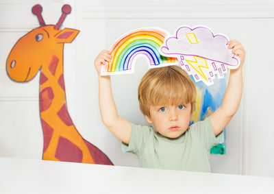 Portrait of cute girl playing with toys on table