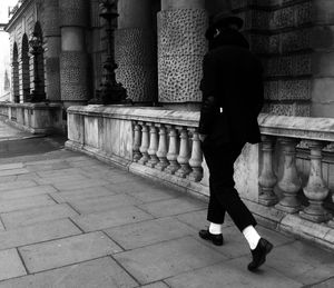 Full length of woman standing on railing