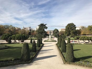 Footpath in garden against sky