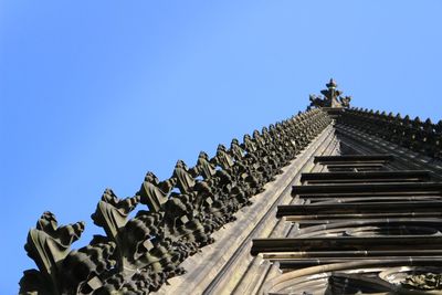 Low angle view of statue against clear blue sky