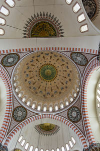 Low angle view of clock on ceiling of building