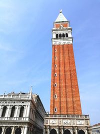 Low angle view of clock tower against blue sky