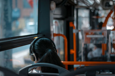 Rear view of woman in train