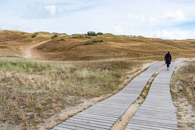 Rear view of man walking on land