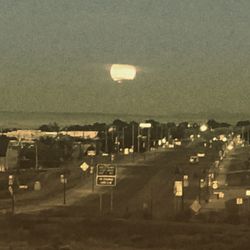 Illuminated built structure against sky at night