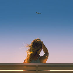 Man flying against clear sky