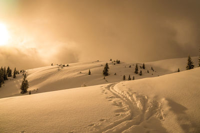 Scenic view of snow covered landscape against sky