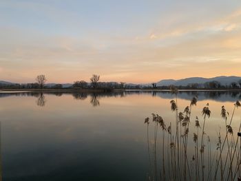 Scenic view of lake against sky during sunset