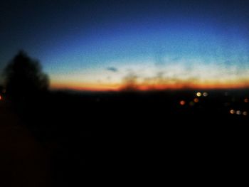 Scenic view of silhouette landscape against sky at night