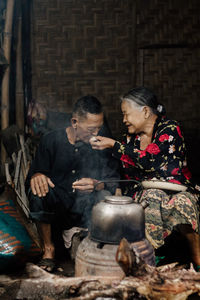 Side view of young woman preparing food at home