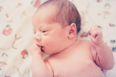 Close-up of cute baby girl at home