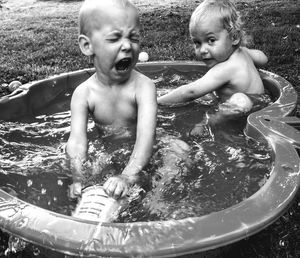 Boys in wadding pool on field