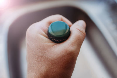 Close-up of hand holding ring