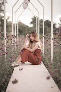 Young woman sitting on field