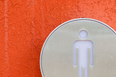 Close-up of restroom sign on wall