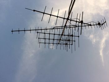Low angle view of television aerial against sky