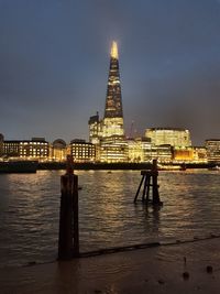 Illuminated city at waterfront