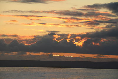 Scenic view of sea against romantic sky at sunset