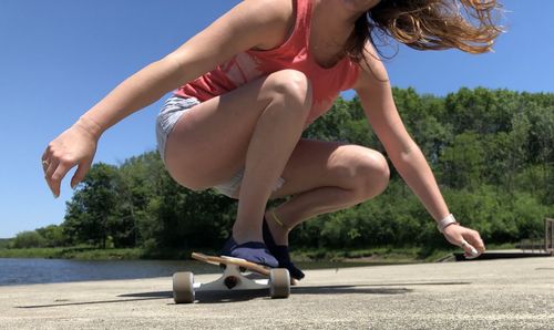 Midsection of woman  skateboarding 