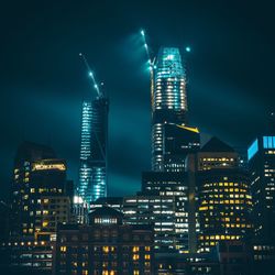 Low angle view of skyscrapers lit up at night