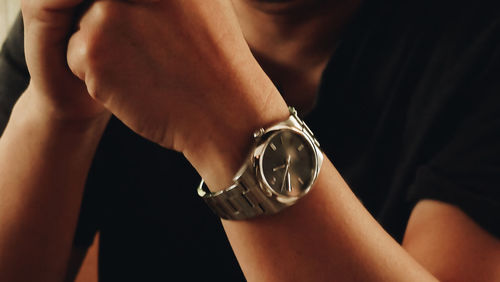 Close-up of man hand holding clock