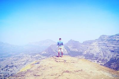 Rear view of man standing on mountain