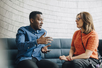 Young couple sitting in front of woman