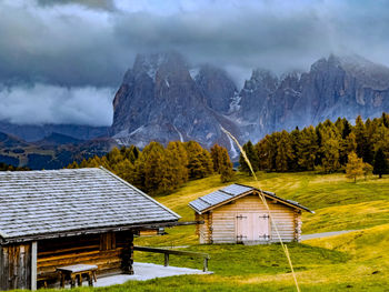 Houses and mountains against sky at seiser alm