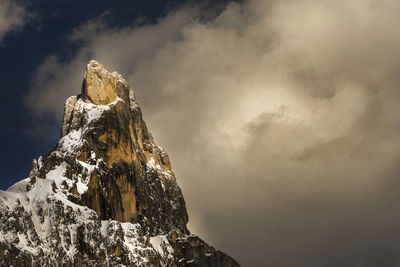 Low angle view of snow covered mountain against sky