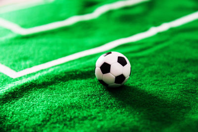 High angle view of miniature soccer ball on grass