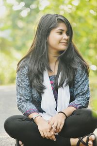 Portrait of woman sitting outdoors