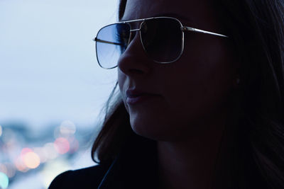 Close-up portrait of young woman wearing sunglasses