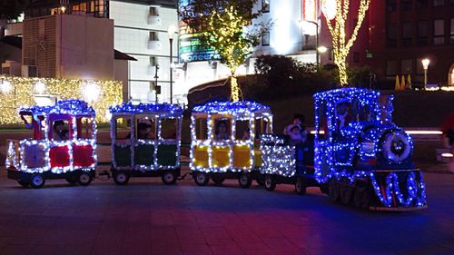 Illuminated christmas lights on street at night