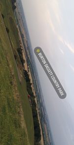 Aerial view of road by sea against sky