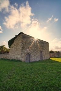 House on field against sky