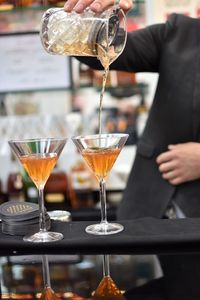 Close-up of wine pouring glasses