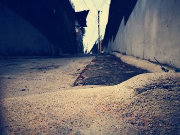 Road amidst buildings against sky