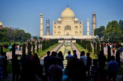 Group of people in front of taj mahal against sky