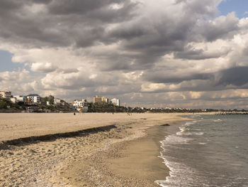 Scenic view of beach against sky in city