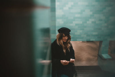 Woman standing against wall