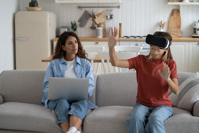 Friends using laptop at home