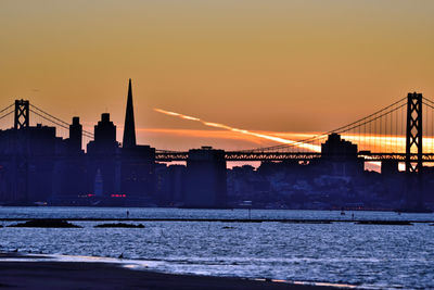 Silhouette of suspension bridge at sunset