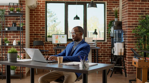 Businessman working on laptop in office