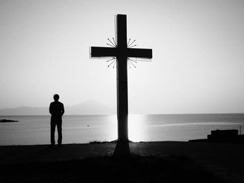 Rear view of silhouette man standing on beach