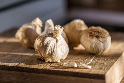 Close-up of garlic on rustic wooden table