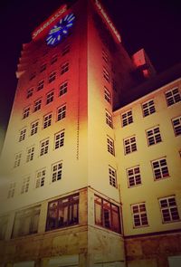 Low angle view of illuminated building against sky at night