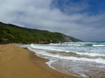 Scenic view of sea against cloudy sky