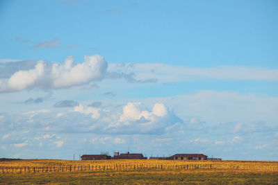 Hay bales on field against sky
