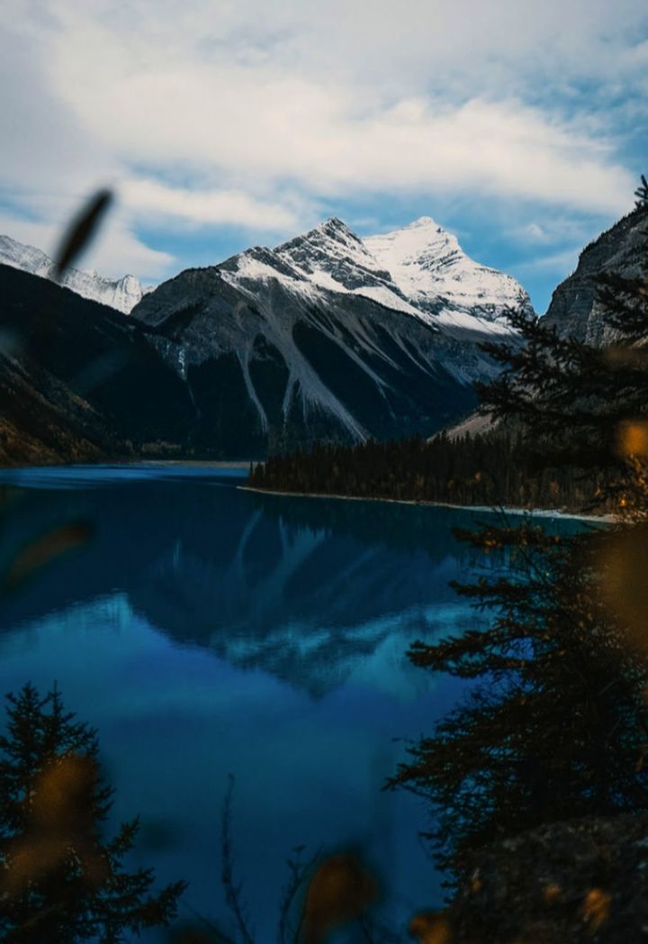 reflection, mountain, nature, scenics - nature, water, snow, beauty in nature, sky, cold temperature, mountain range, environment, lake, winter, cloud, landscape, snowcapped mountain, tranquil scene, tranquility, tree, no people, wilderness, travel destinations, land, morning, plant, travel, outdoors, non-urban scene, mountain peak, forest, idyllic, day, tourism